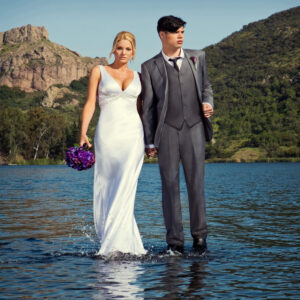 bride and groom walking on water photoshoot